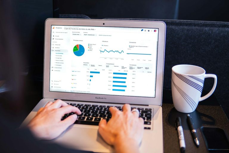 SEO specialist doing keyword research on a laptop with analytics data