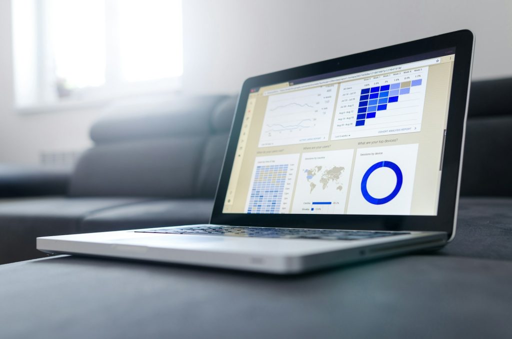 Notebook and laptop with charts used for a monthly Google Search Console review