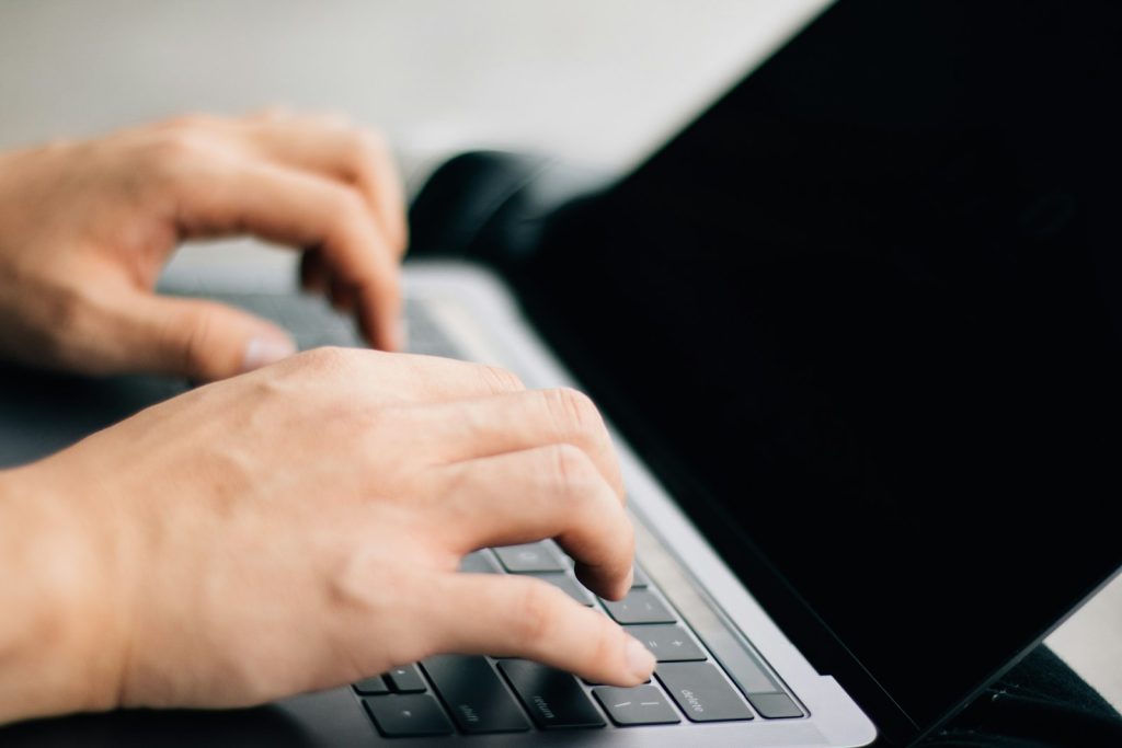 Malaysian business owner typing on a laptop while setting up Google Search Console