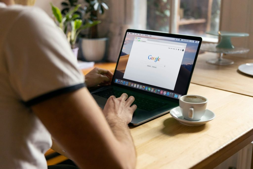 Business owner planning an SEO vs SEM strategy on a laptop